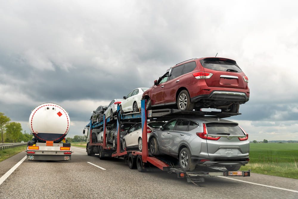 transporting cars on an open carrier truck